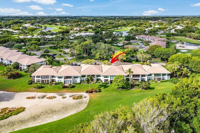 aerial view of residential area featuring a nearby body of water and a local golf course