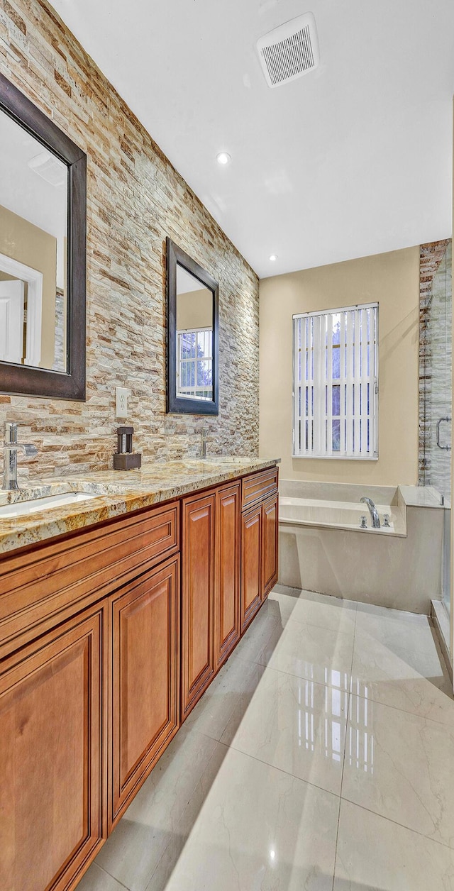 full bath featuring a garden tub, double vanity, recessed lighting, plenty of natural light, and a shower with door