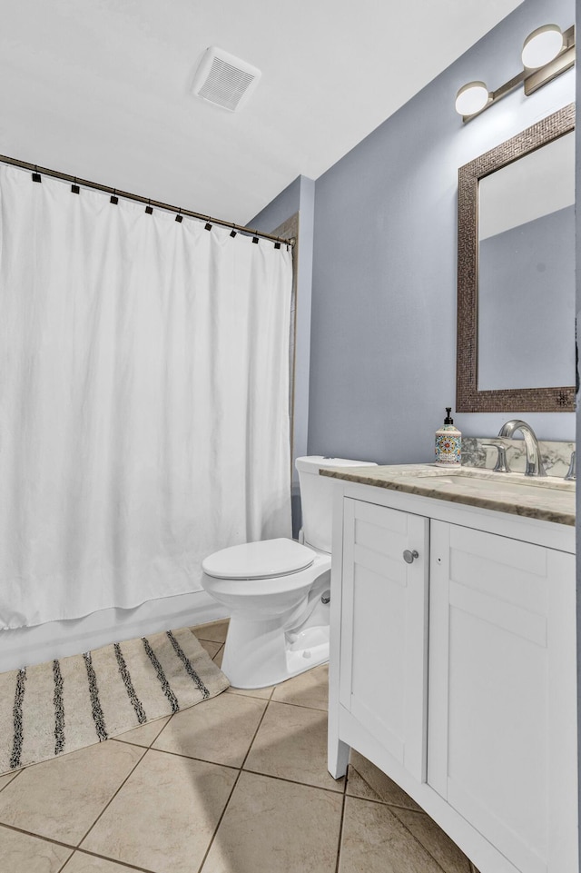 full bathroom with toilet, vanity, tile patterned flooring, and shower / bath combo with shower curtain