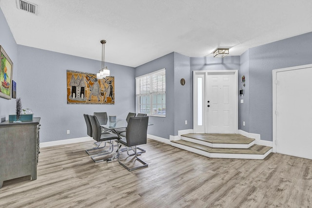 dining room featuring wood finished floors and baseboards