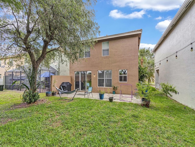 rear view of property with stucco siding and a patio