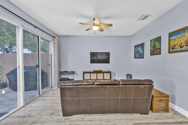 living area featuring ceiling fan, wood finished floors, and baseboards