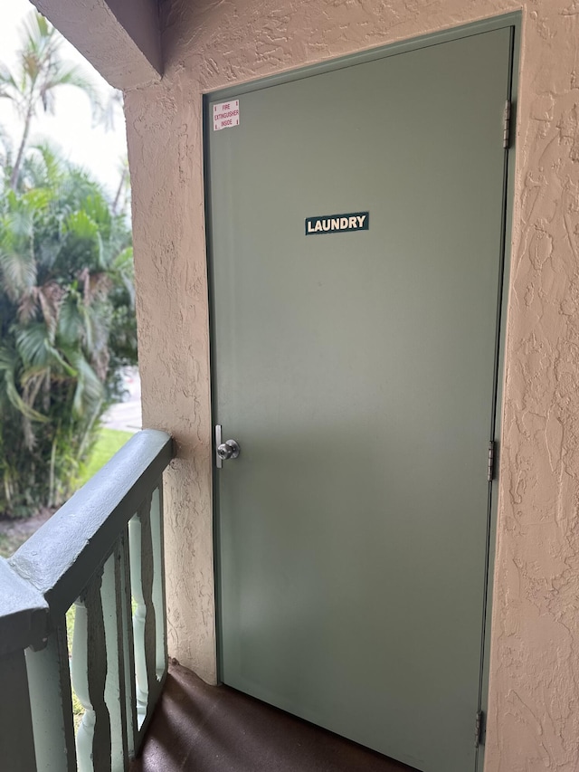 property entrance with stucco siding