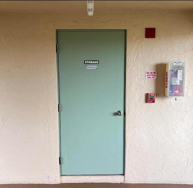 entrance to property featuring stucco siding