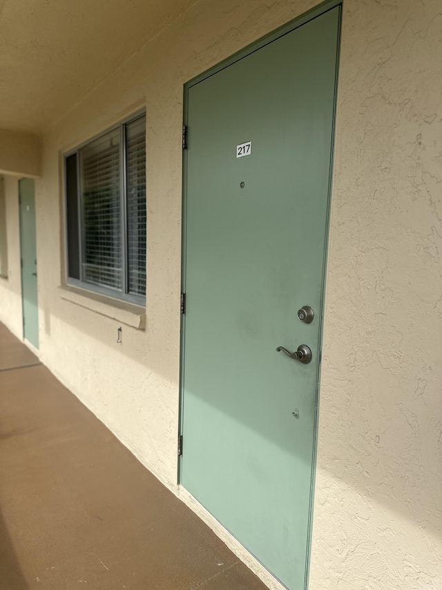 doorway to property with stucco siding