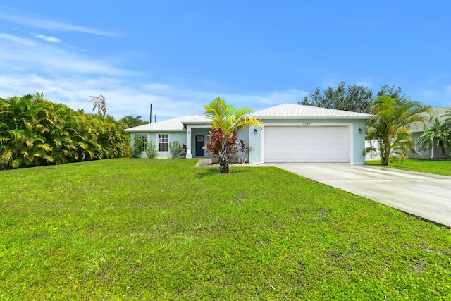 ranch-style house featuring driveway, an attached garage, stucco siding, and a front yard