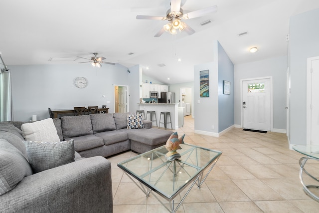 living area featuring ceiling fan, light tile patterned floors, baseboards, and high vaulted ceiling