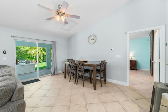 dining area with light tile patterned flooring, vaulted ceiling, ceiling fan, and baseboards