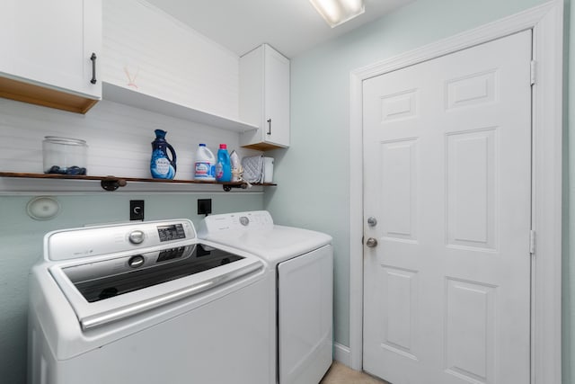 laundry area featuring independent washer and dryer and cabinet space
