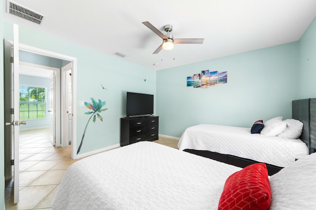 bedroom with baseboards, light tile patterned flooring, and a ceiling fan