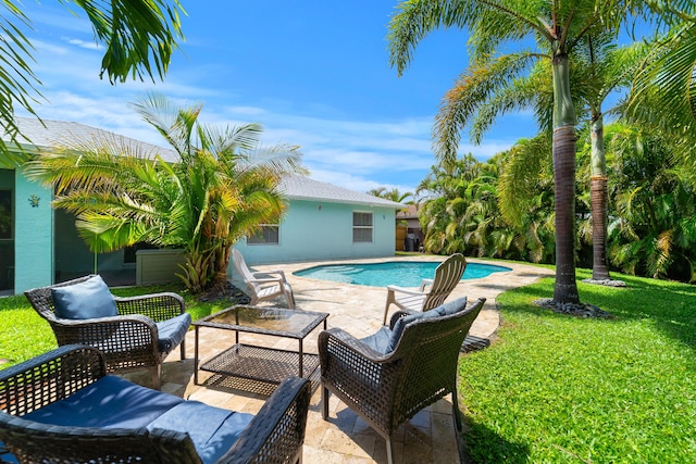 swimming pool featuring a patio, a lawn, and an outdoor living space