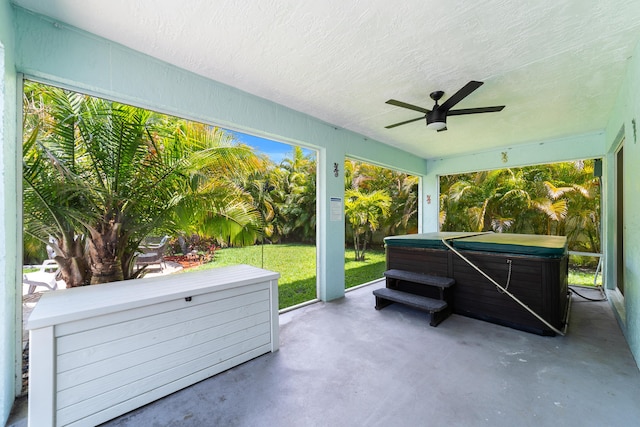 sunroom with a hot tub and ceiling fan