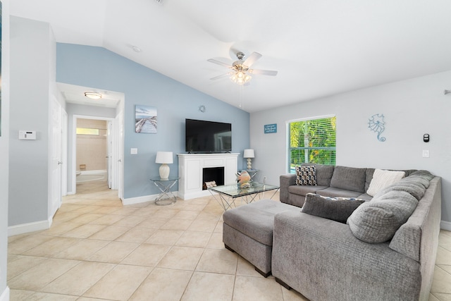 living room with vaulted ceiling, ceiling fan, light tile patterned flooring, a fireplace, and baseboards