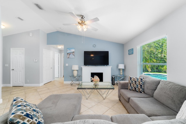 living room with light tile patterned flooring, vaulted ceiling, ceiling fan, baseboards, and a fireplace