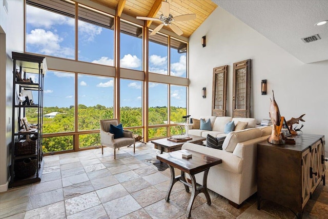 3781 NE Sugarhill Ave, Jensen Beach, FL 34957 - sunroom featuring stone tile floors, a water view, and a towering ceiling