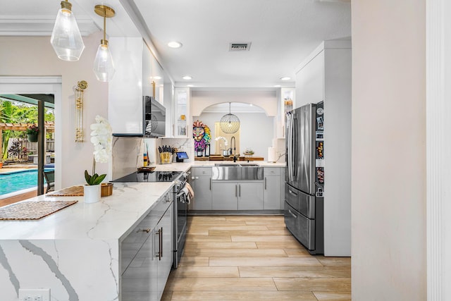 1707 NW 38th St, Oakland Park, FL 33309 - kitchen with stainless steel appliances, gray cabinetry, a peninsula, recessed lighting, and light wood-type flooring