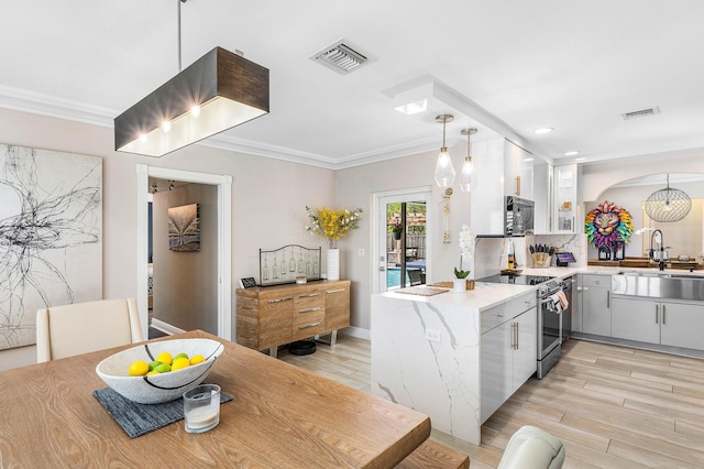 1707 NW 38th St, Oakland Park, FL 33309 - kitchen featuring light wood finished floors, stainless steel range with electric cooktop, visible vents, and a sink