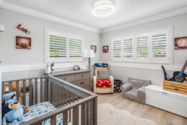 1707 NW 38th St, Oakland Park, FL 33309 - bedroom with ornamental molding, a crib, multiple windows, and wood finished floors