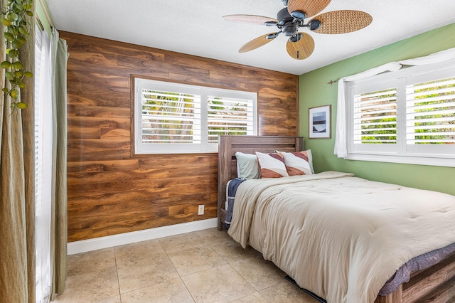 1707 NW 38th St, Oakland Park, FL 33309 - bedroom with wood walls, a ceiling fan, and baseboards
