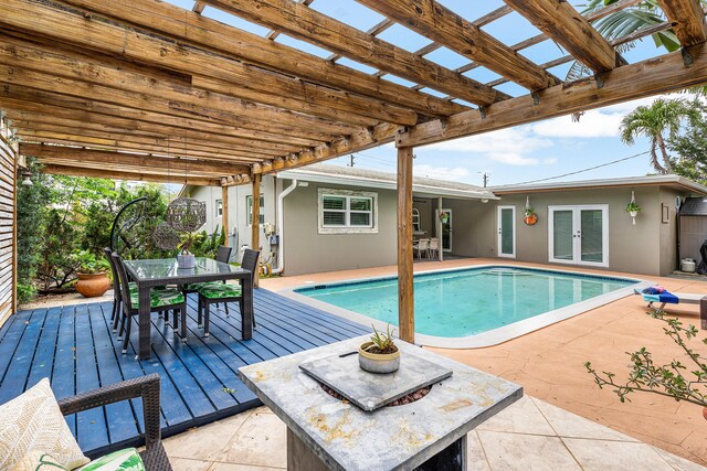1707 NW 38th St, Oakland Park, FL 33309 - outdoor pool with french doors, outdoor dining space, and a pergola
