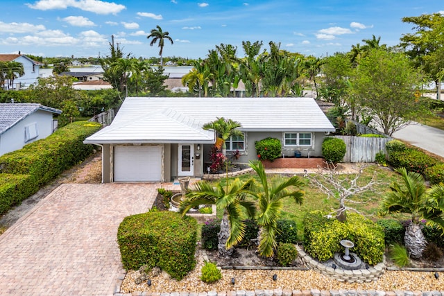 1707 NW 38th St, Oakland Park, FL 33309 - ranch-style house with driveway, fence, a garage, stucco siding, and a tile roof