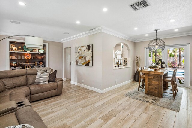 1707 NW 38th St, Oakland Park, FL 33309 - living area with visible vents, recessed lighting, light wood finished floors, arched walkways, and baseboards
