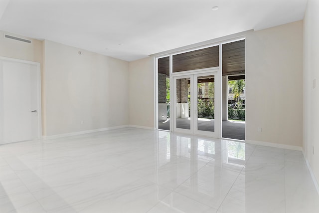 unfurnished room featuring baseboards and marble finish floors