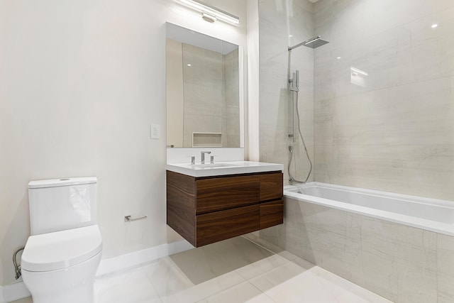bathroom featuring tiled shower / bath combo, vanity, toilet, and baseboards