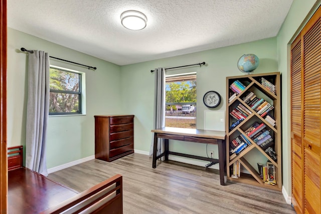 13298 82nd St N, West Palm Beach, FL 33412 - bedroom with a textured ceiling, wood finished floors, a closet, and baseboards