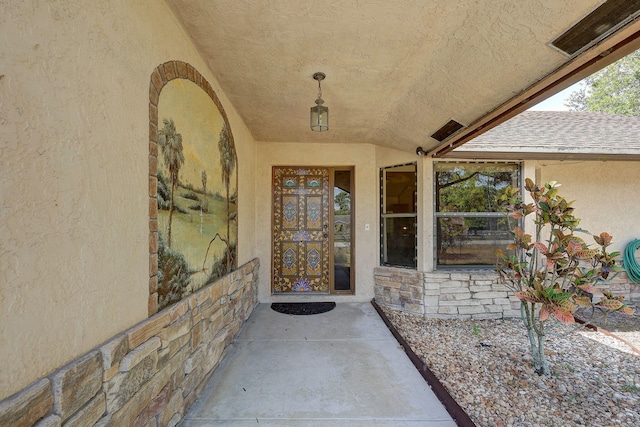 13298 82nd St N, West Palm Beach, FL 33412 - property entrance with stucco siding, stone siding, and a shingled roof