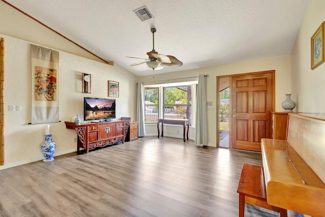 13298 82nd St N, West Palm Beach, FL 33412 - living area with ceiling fan, lofted ceiling, wood finished floors, and a textured ceiling