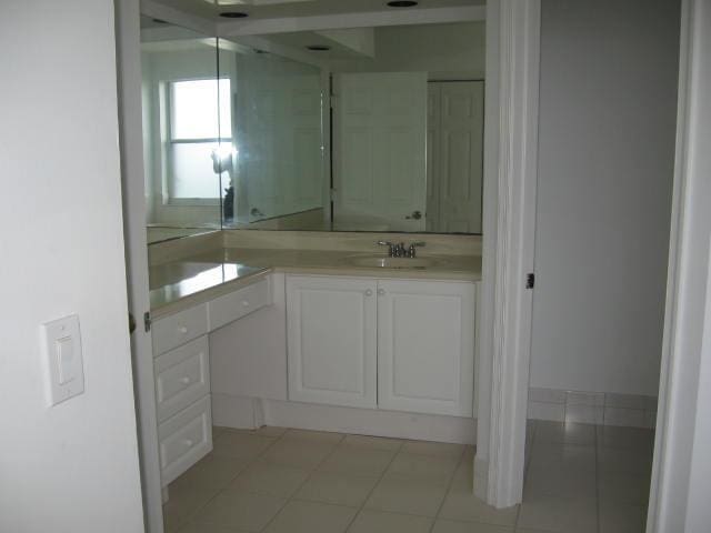 bathroom featuring tile patterned flooring and vanity