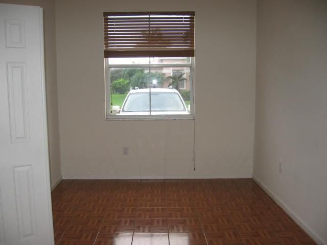 spare room with baseboards