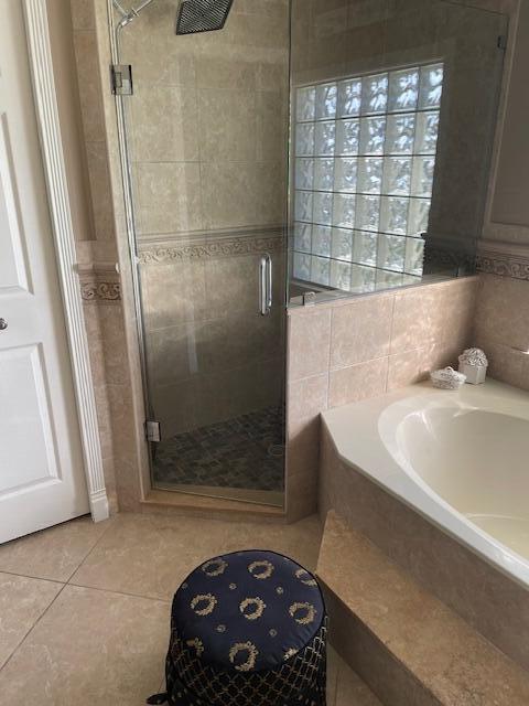 1618 SW Lexington Dr NW, Port Saint Lucie, FL 34953 - bathroom with tile patterned floors, a stall shower, and a garden tub