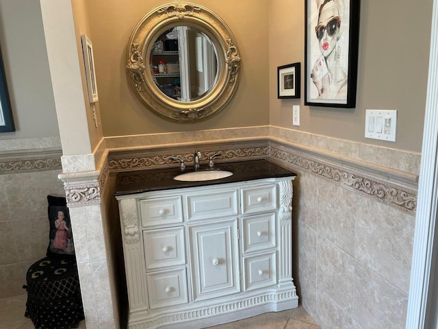 1618 SW Lexington Dr NW, Port Saint Lucie, FL 34953 - bathroom featuring a wainscoted wall, tile walls, vanity, and tile patterned floors
