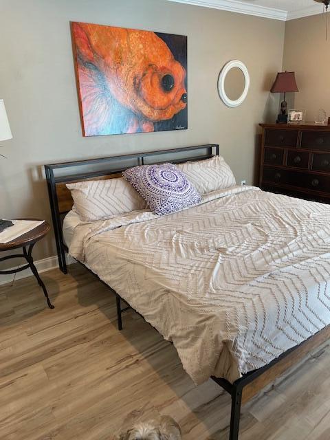 1618 SW Lexington Dr NW, Port Saint Lucie, FL 34953 - bedroom with crown molding, wood finished floors, and baseboards