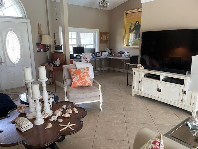 1618 SW Lexington Dr NW, Port Saint Lucie, FL 34953 - living area featuring an office area, light tile patterned floors, and vaulted ceiling