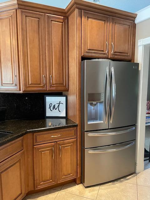1618 SW Lexington Dr NW, Port Saint Lucie, FL 34953 - kitchen with stainless steel fridge and brown cabinets
