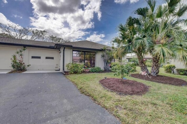 4728 Finchwood Rd Unit B, Boynton Beach, FL 33436 - view of front of home with asphalt driveway, stucco siding, an attached garage, and a front lawn