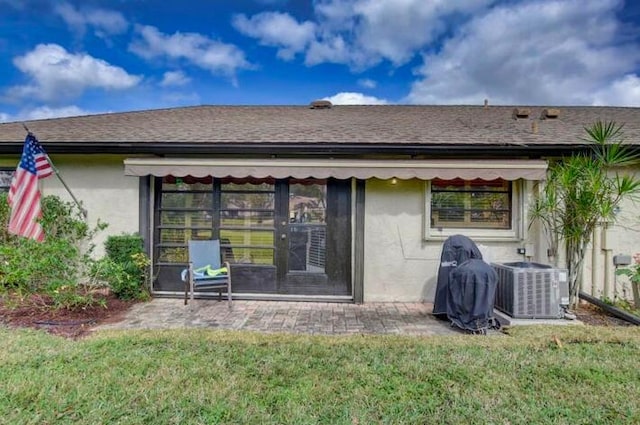 4728 Finchwood Rd Unit B, Boynton Beach, FL 33436 - rear view of property featuring central AC unit, stucco siding, a patio area, and a yard