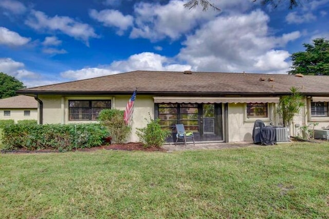 4728 Finchwood Rd Unit B, Boynton Beach, FL 33436 - rear view of house with stucco siding, a yard, and central air condition unit