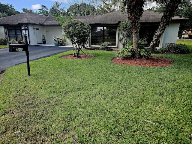 4728 Finchwood Rd Unit B, Boynton Beach, FL 33436 - ranch-style home featuring a garage, driveway, a front lawn, and stucco siding