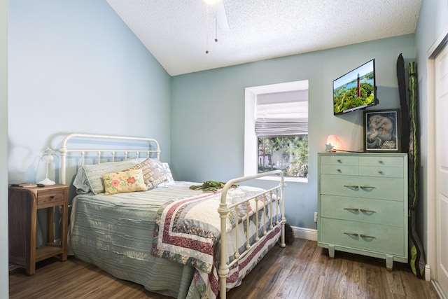 bedroom with wood finished floors, baseboards, lofted ceiling, and a textured ceiling