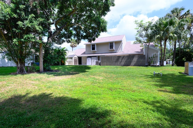 view of grassy yard featuring central AC unit