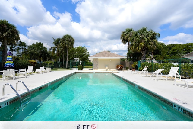 community pool featuring a patio area and fence
