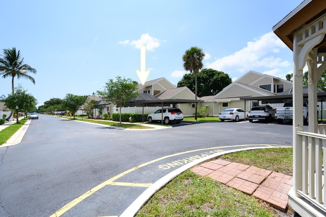 view of asphalt road with a residential view