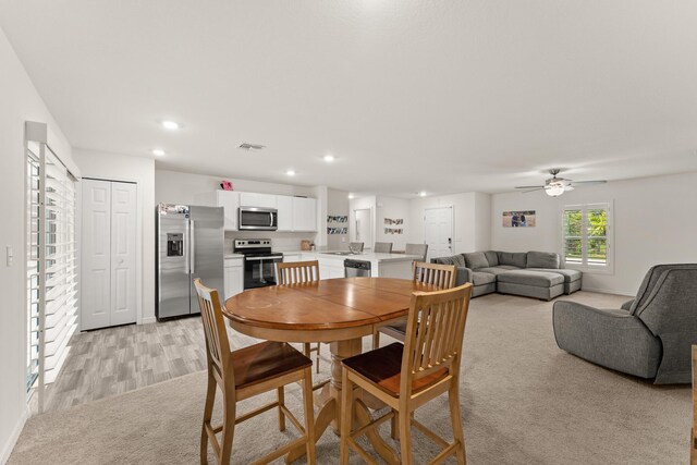 5248 NW Gamma St, Port Saint Lucie, FL 34986 - dining space featuring recessed lighting, ceiling fan, light colored carpet, baseboards, and light wood-style floors