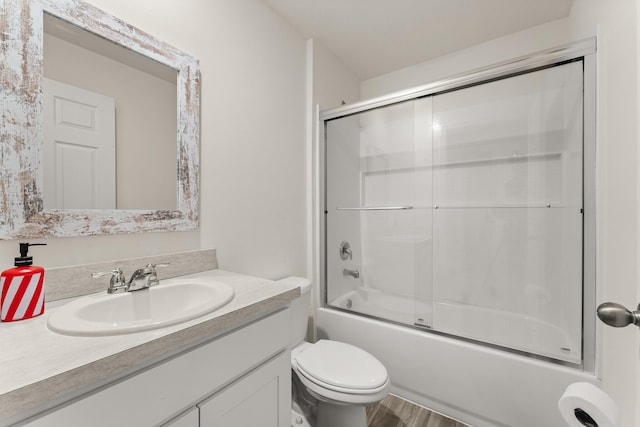5248 NW Gamma St, Port Saint Lucie, FL 34986 - full bath with toilet, vanity, shower / bath combination with glass door, and wood finished floors