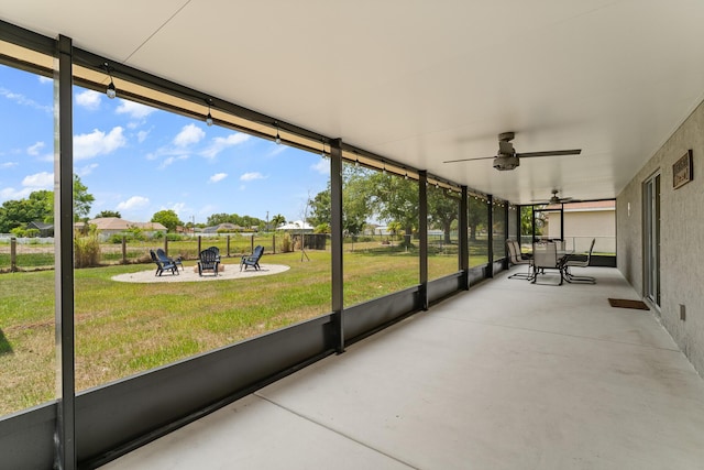 5248 NW Gamma St, Port Saint Lucie, FL 34986 - unfurnished sunroom featuring an outdoor fire pit, a ceiling fan, and plenty of natural light