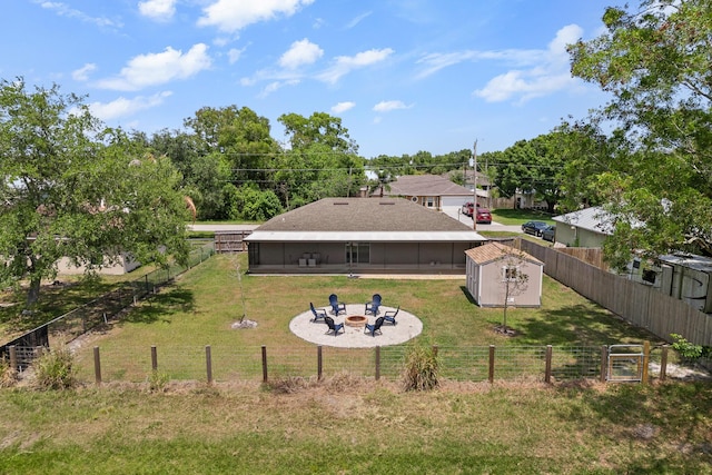 5248 NW Gamma St, Port Saint Lucie, FL 34986 - view of yard featuring a fire pit, a storage unit, and an outbuilding
